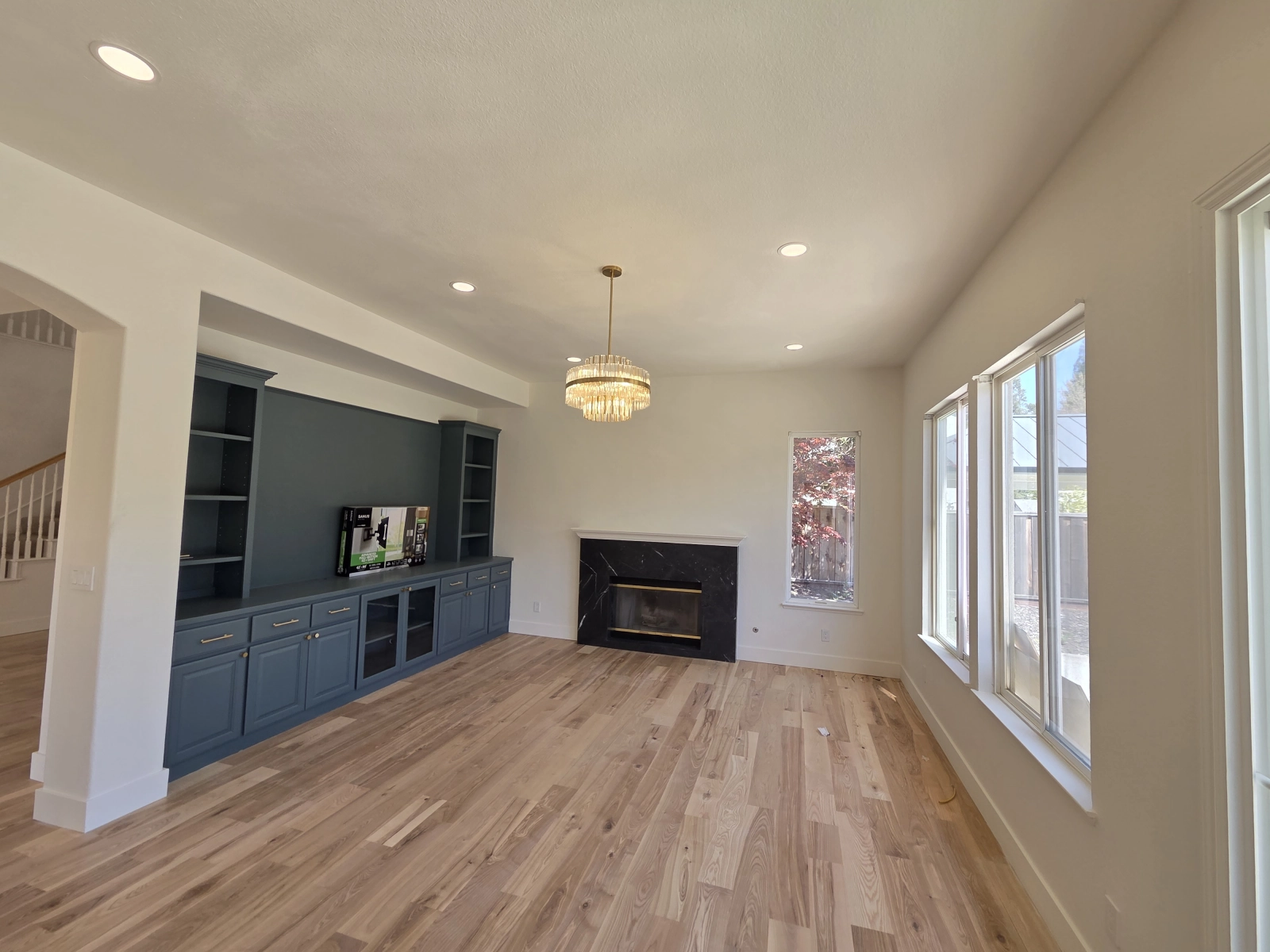 9Builders: Modern Living Room with Custom Built-In Cabinetry and Fireplace