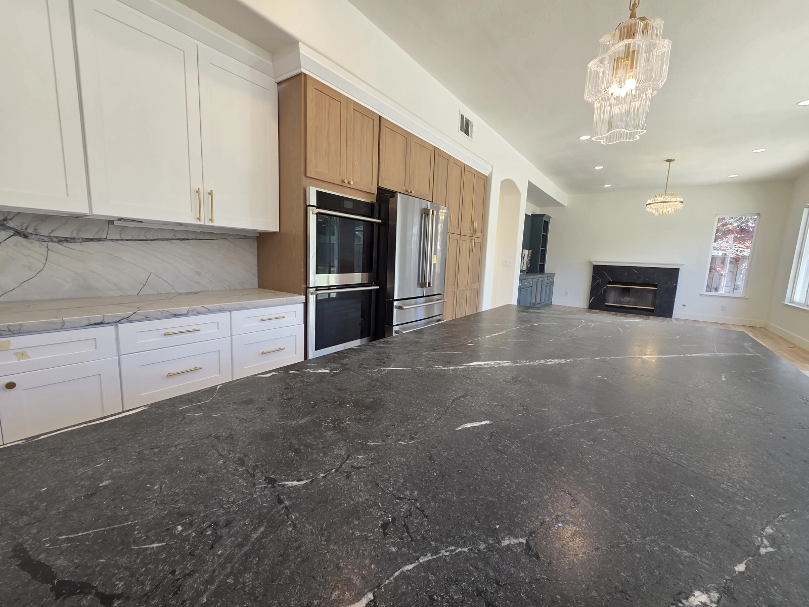 9Builders: Stylish and Functional Kitchen with Marble Countertops and Gold Accents