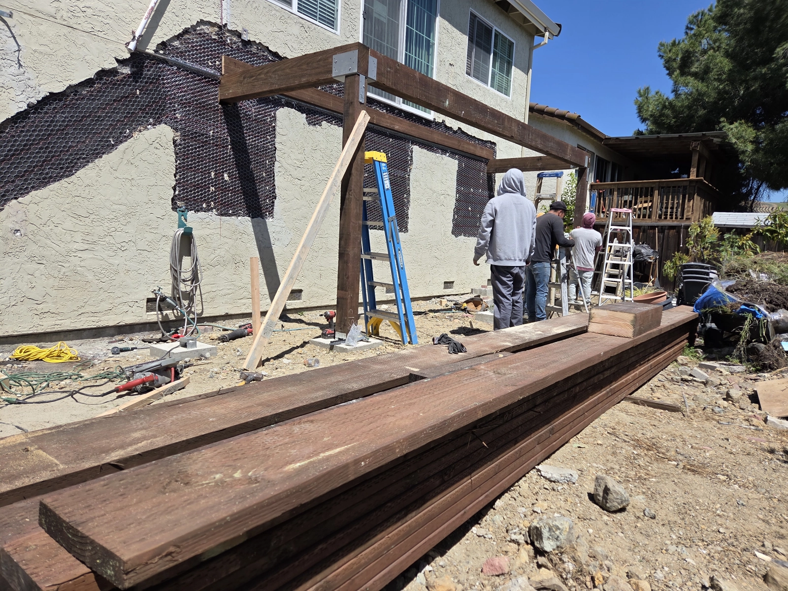 Workers preparing lumber for installation