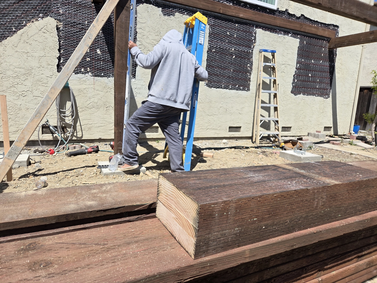 Close-up of wood post secured to concrete base